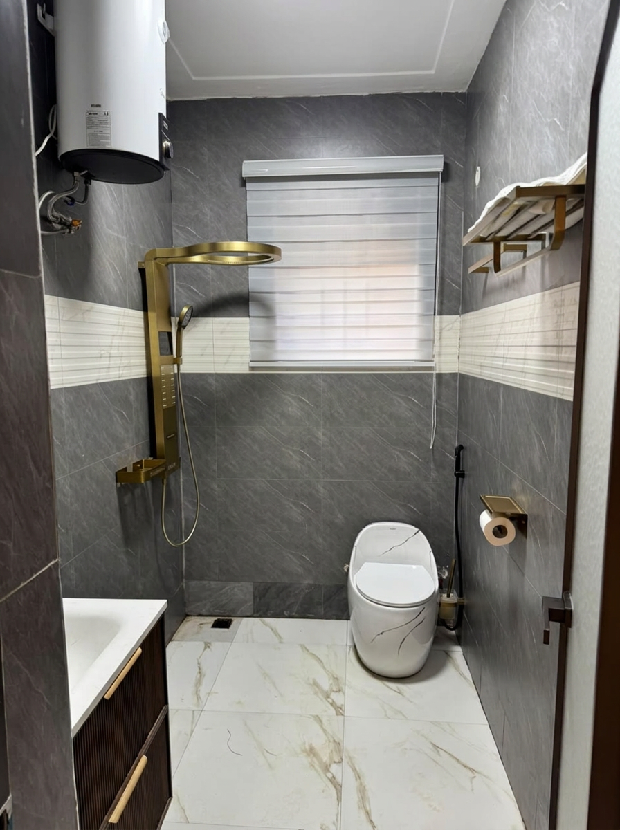 Modern tiled bathroom with gold shower fittings